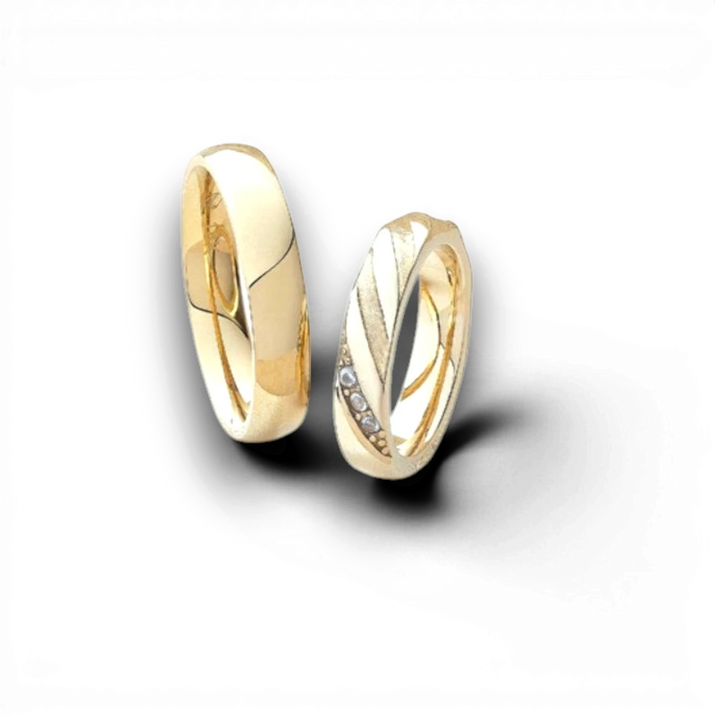 Amaranthus Gold pair of 18k gold plated titanium wedding rings, one with diamonds, on a gold branch.
